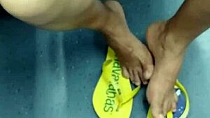 The candid Brazilian girl engages in playful shoeplay with her flip flops in a hidden spot