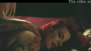 two tattooed bisexual girls dive into fun with a bbc strapon, exploring big asses, natural tits, and sensual pussy licking in an oiled lesbian encounter