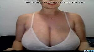 Huge titted milf massages big boobs on webcam in amateur video.