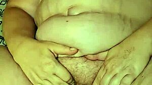 She teases her pussy with a dildo until she cums hard in the bedroom