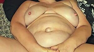 She teases her pussy with a dildo until she cums hard in the bedroom