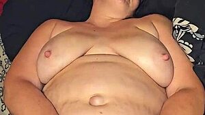 She teases her pussy with a dildo until she cums hard in the bedroom