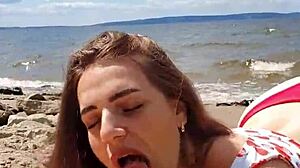 beautiful brunette gives deepthroat blowjob outdoors by the river in close-up