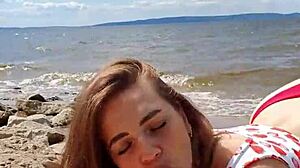 beautiful brunette gives deepthroat blowjob outdoors by the river in close-up