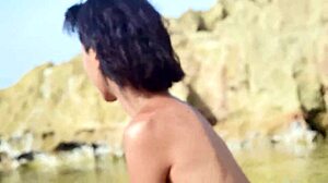 Skinny brunette strips panties and teases hairy pussy on public beach