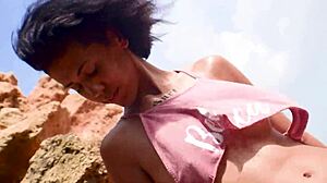 Skinny brunette strips panties and teases hairy pussy on public beach