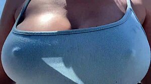 Artemisia Love struts outdoors braless with big tits bouncing