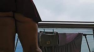 naughty maid flashes big ass skirt on balcony