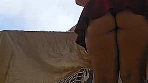 naughty maid flashes big ass skirt on balcony