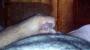 guy strokes his hard cock furiously on the bed