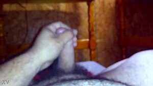 guy strokes his hard cock furiously on the bed