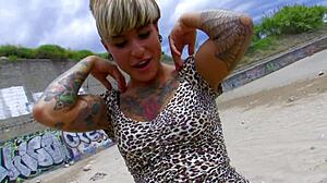 tattooed short haired milf rides cock wildly on sunny beach