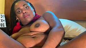 Ebony with big black tits fucks herself dripping wet