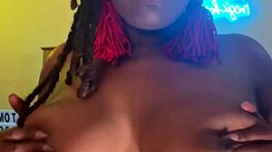 Ebony with big black tits fucks herself dripping wet