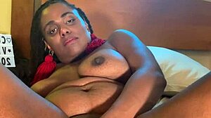 Ebony with big black tits fucks herself dripping wet