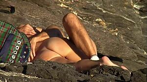 mature couple pounds passionately on sunny beach