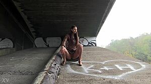 kitty squats outdoors unleashing golden stream solo