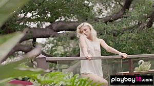 Skinny blonde July Miller strips naked and spreads shaved pussy in forest