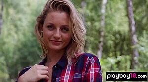 Skinny blonde July Miller strips naked and spreads shaved pussy in forest