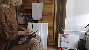 blonde babe in boots spreads legs painting her pretty pussy flower close-up