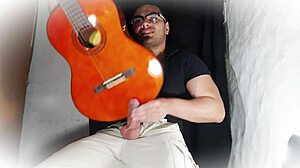 muscular stud jerks 18cm cock on guitar till cumshot