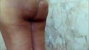 Chubby Indian girl whispers dirty talk while fingering her big tits in bathroom