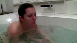 Shy Angela fingers shaved pussy in bath