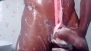 A black amateur babe soaps up her curves having fun in the shower