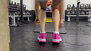 Muscular Brunette Works Out Wet Pussy in Gym Leg Spreads