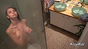 Why does busty Kecy linger naked in shower revealing natural big tits?