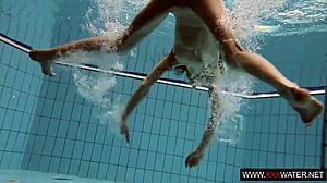 brunette cutie janka with long hair swims underwater in pool