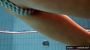 brunette cutie janka with long hair swims underwater in pool