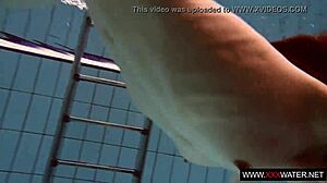 brunette cutie janka with long hair swims underwater in pool