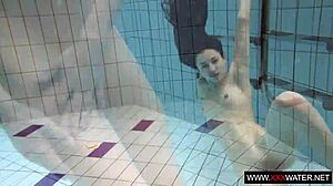 brunette cutie janka with long hair swims underwater in pool