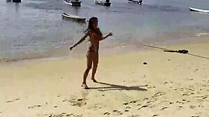 Monika Fox's pink bikini barely hides her stars as she poses teasingly on the beach