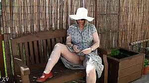 naughty housewife strips naked outdoors in lush garden