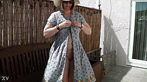 naughty housewife strips naked outdoors in lush garden