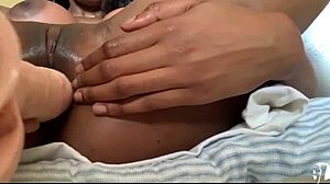 ebony babe strips and squirts on huge bedroom dildo!