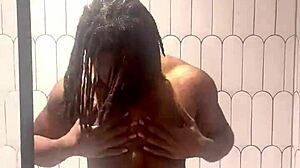 busty babe oils slick tits and ass in shower