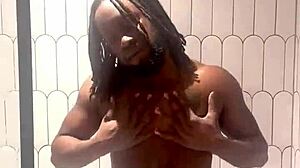 busty babe oils slick tits and ass in shower