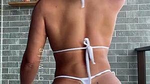 married babe tests her naughty sheer bikinis on the balcony view