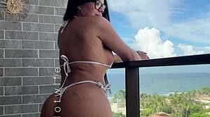 married babe tests her naughty sheer bikinis on the balcony view