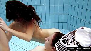 Shaved big-titted brunette teases tight pussy in underwater shower