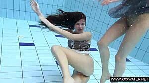 Shaved big-titted brunette teases tight pussy in underwater shower