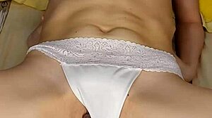 girl in white lingerie fucks herself with pink dildo