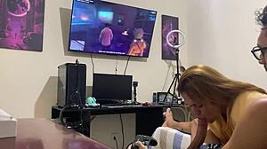 petite brunette assists while he plays video game