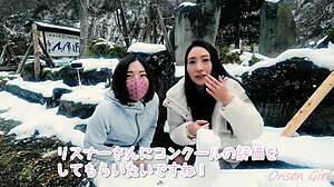 asian girl creates snow sculpture art with white cat